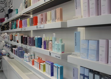 Product display shelves at Hair Signature Beauty Lounge, Dubai, AE showcasing various beauty products.