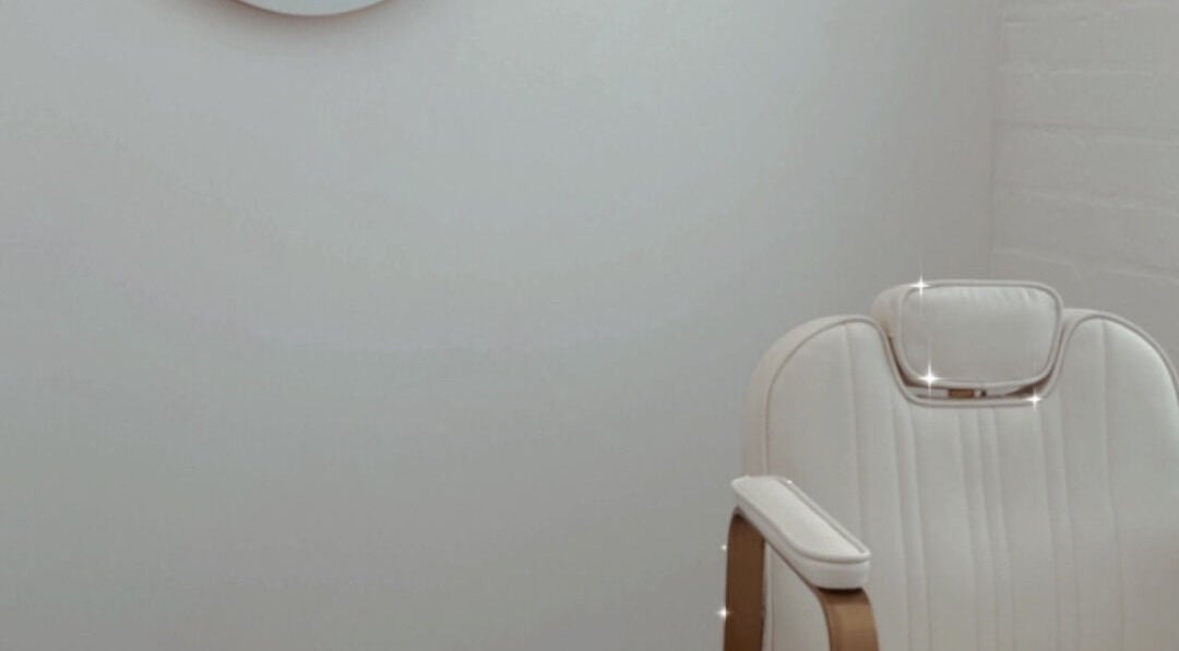 Luxurious white treatment chair at Oh So Pretty Aesthetics, Douglas, IM, offering premium wellness experiences.