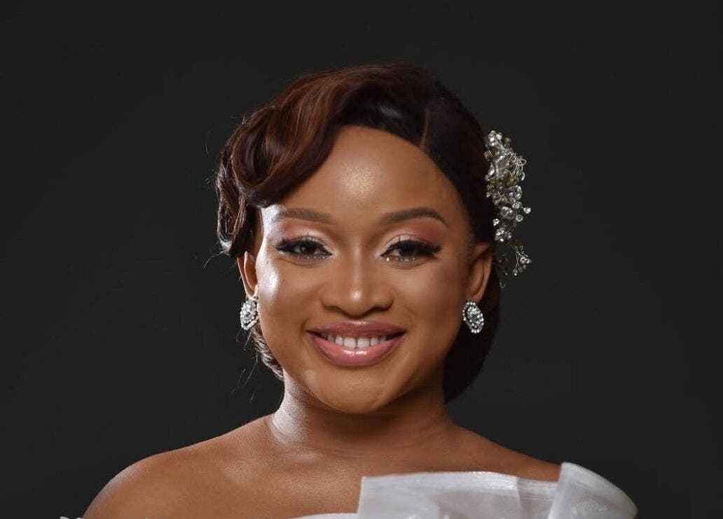Woman with radiant smile and elegant accessories at Mubapro, Manchester, England, GB.