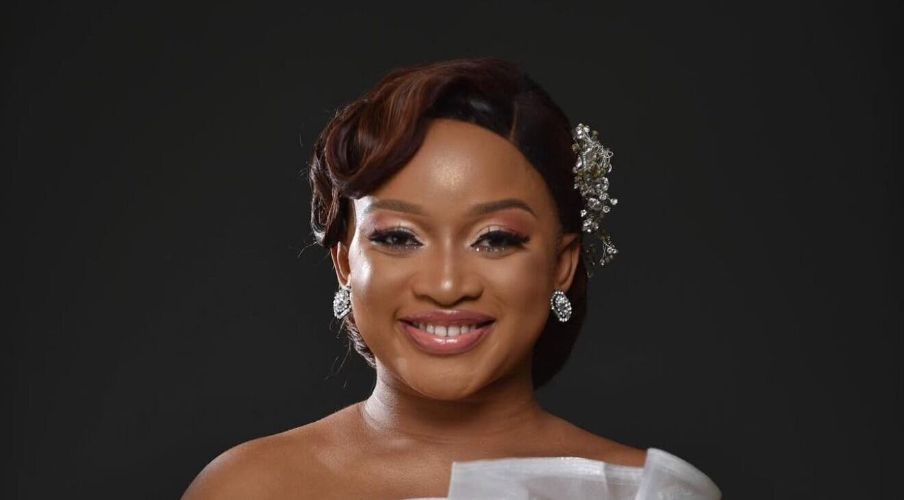 Woman with radiant smile and elegant accessories at Mubapro, Manchester, England, GB.