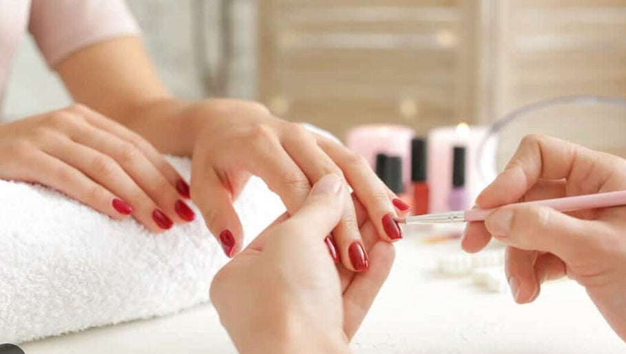 Professional manicure at Holly's Nails in Vancouver, British Columbia, CA, featuring elegant red nails.