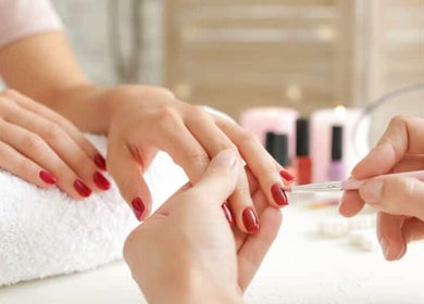 Professional manicure at Holly's Nails in Vancouver, British Columbia, CA, featuring elegant red nails.