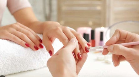 Professional manicure at Holly's Nails in Vancouver, British Columbia, CA, featuring elegant red nails.
