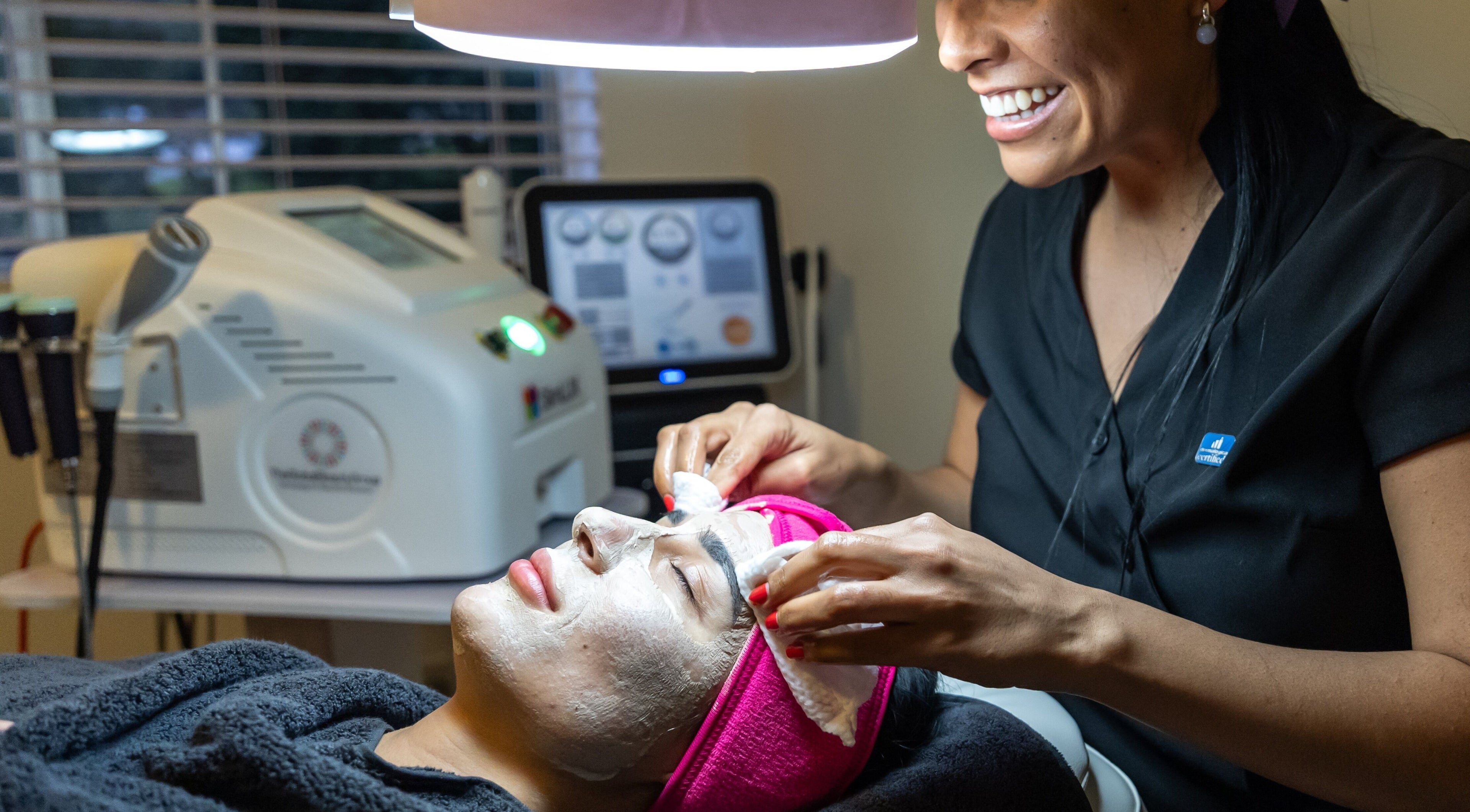 Esthetician applying facial treatment at Carols Glow Beauty, Cremorne, New South Wales, AU.