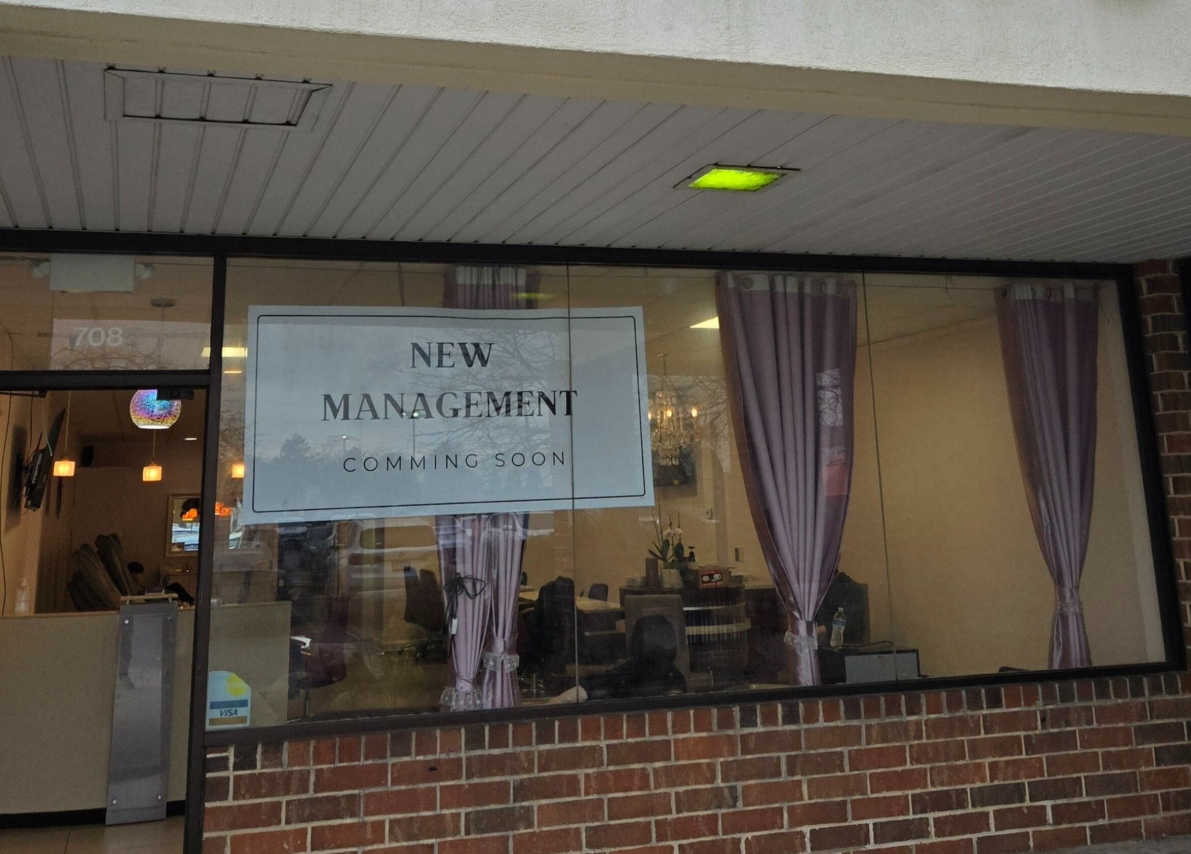 Exterior of DIF Nails in Schaumburg, Illinois, US under new management with purple curtains visible.