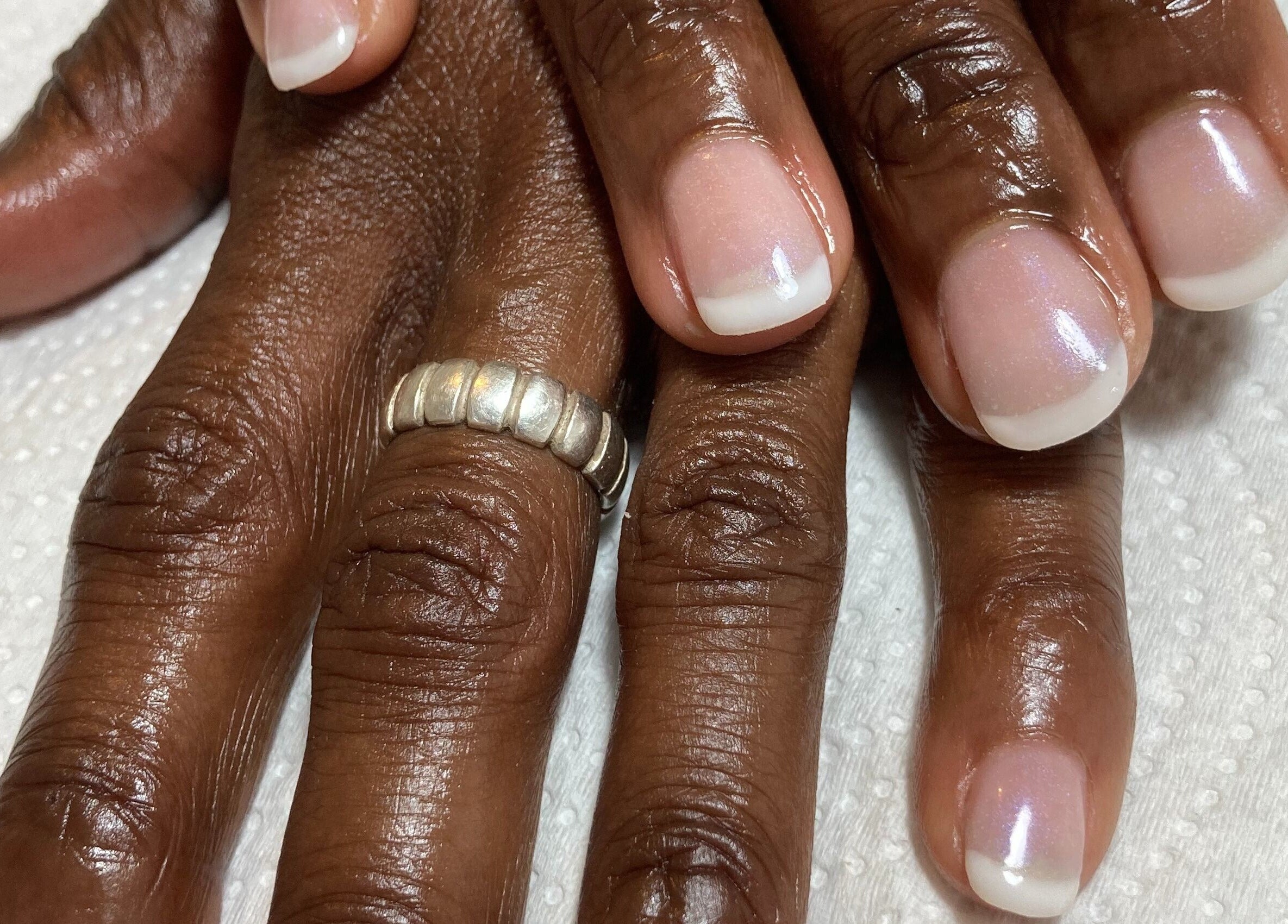 Freshly manicured hands at Oval & Arch at 17 Mary Days Goudhurst, Goudhurst, England, GB showcasing glossy nails.