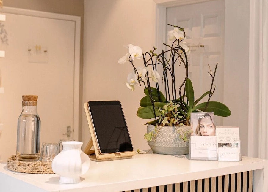 Reception area at Oval & Arch at Nuve Clinic, Cranbrook, England with elegant decor and orchids.