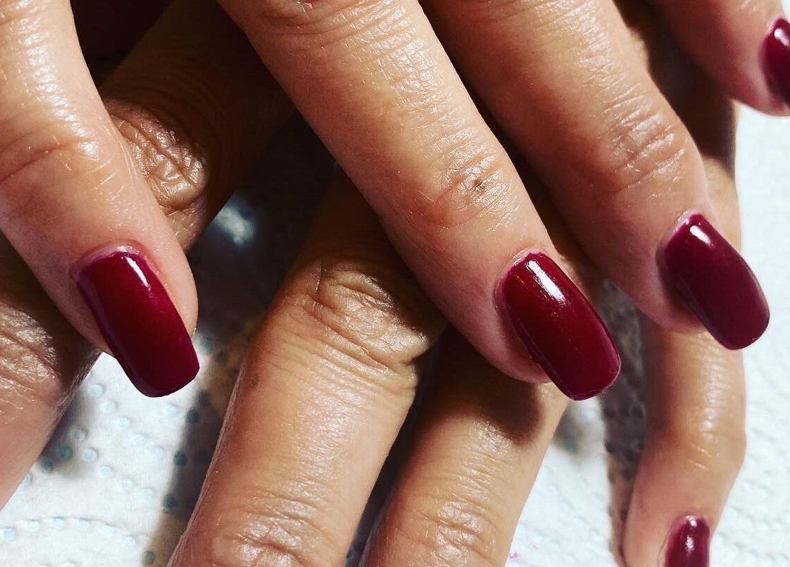 Elegant maroon manicure at Oval & Arch at Nuve Clinic, Cranbrook, England, GB.