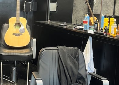 Stevenconroyhair salon in Portlaoise, County Laois, IE with a guitar on a chair reflecting a laid-back vibe.