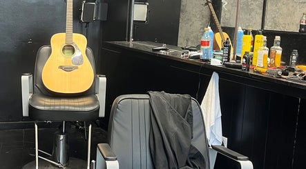 Stevenconroyhair salon in Portlaoise, County Laois, IE with a guitar on a chair reflecting a laid-back vibe.