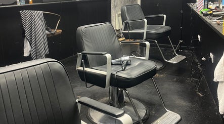 Modern black salon chairs at RUDEBOYS, Portlaoise, County Laois, IE, showcasing a stylish barber setup.