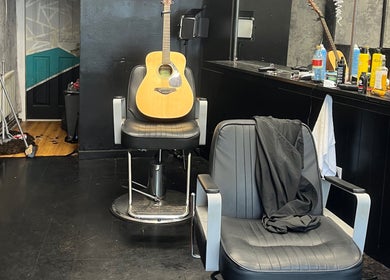 Interior of RUDEBOYS in Portlaoise, County Laois, IE, featuring a guitar resting on a barber chair.