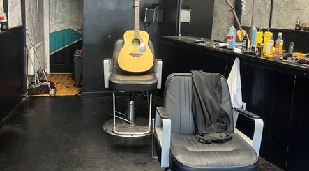 Interior of RUDEBOYS in Portlaoise, County Laois, IE, featuring a guitar resting on a barber chair.