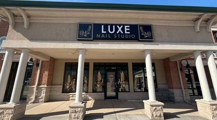 Entrance of Luxe Nail Studio in Madison, Wisconsin, US featuring classic columns and signage.