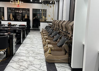 Luxe Nail Studio in Madison, WI, showcases elegant pedicure chairs and chic black manicure stations.