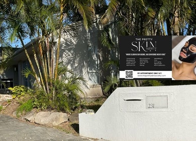 Entrance to The Pretty Skin Society in Warana, Queensland, AU, with lush greenery and modern signage.