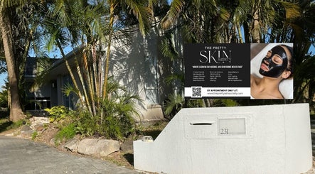 Entrance to The Pretty Skin Society in Warana, Queensland, AU, with lush greenery and modern signage.
