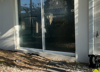Exterior view of The Pretty Skin Society in Warana, Queensland, showing reflective glass windows and modern design.