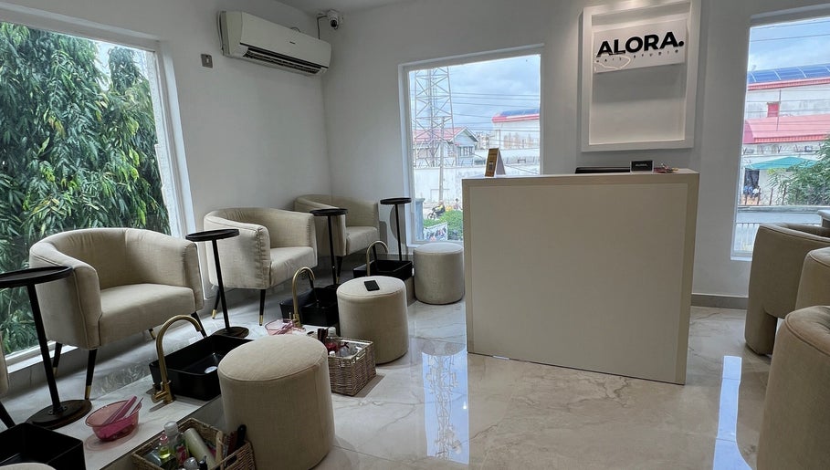 Bright interior of Alora Nail Studio in Lagos, Lagos, NG showcasing plush seating and elegant décor.
