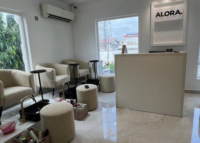 Bright interior of Alora Nail Studio in Lagos, Lagos, NG showcasing plush seating and elegant décor.