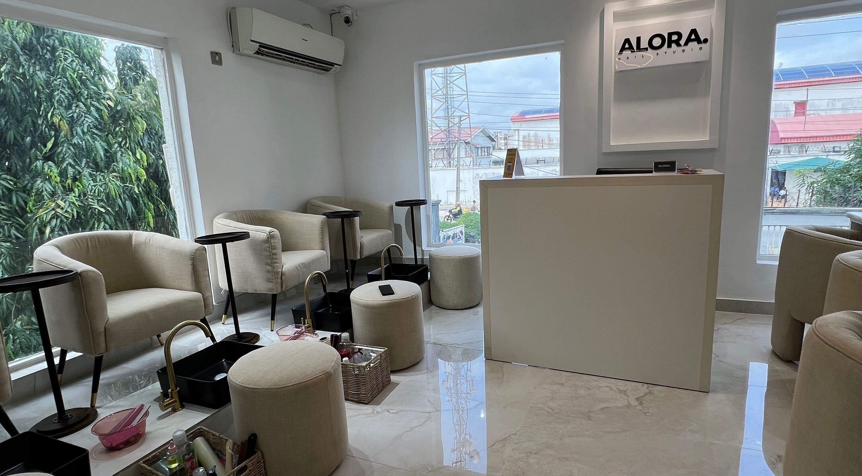 Bright interior of Alora Nail Studio in Lagos, Lagos, NG showcasing plush seating and elegant décor.