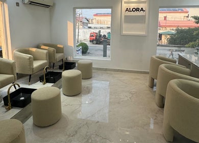 Elegant seating area at Alora Nail Studio, Lagos, Lagos, NG with plush chairs and foot spas.