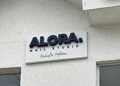 Alora Nail Studio sign on entrance, located at Lagos, Lagos, NG.