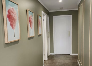 Stylish corridor at Daisy Rose Beauty by Design, Bridgewater, Tasmania, AU, featuring elegant framed artwork.