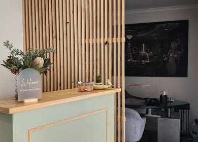 Welcoming reception at Daisy Rose Beauty by Design, Bridgewater, Tasmania, AU, featuring a stylish wooden panel.