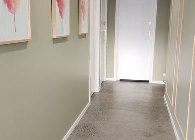 Elegant hallway at Daisy Rose Beauty by Design, Bridgewater, Tasmania, AU with art on soft green walls.