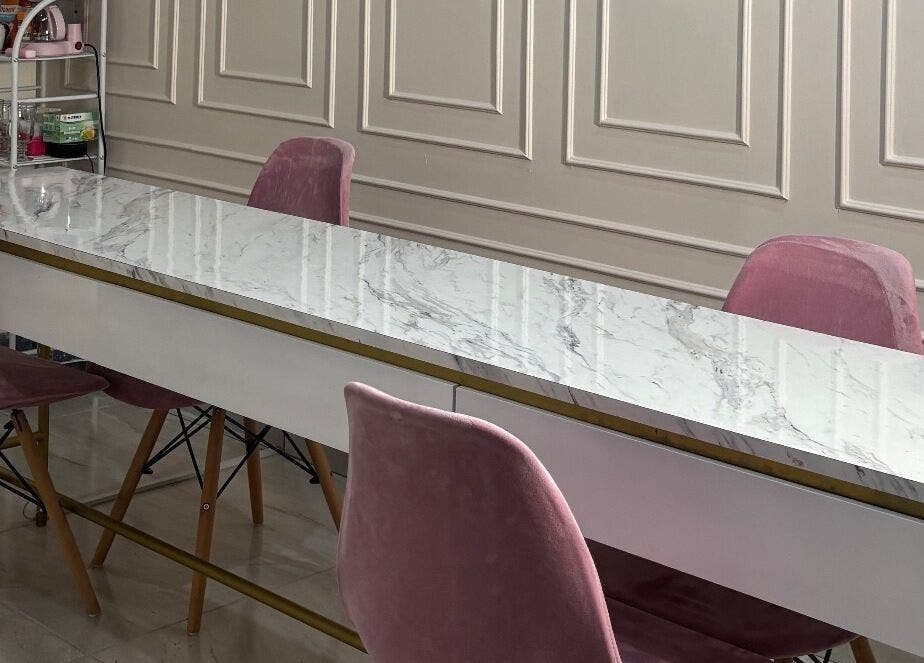 Mesa de mármol y sillas rosadas en Rebeca Peña Integral Beauty Studio, Los Mochis, Sinaloa, MX.