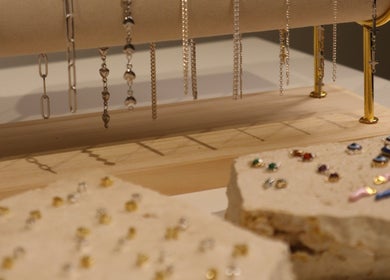Elegant jewelry display at Solderella Studio, Melbourne, Victoria, AU showcasing intricate chains and stud earrings.
