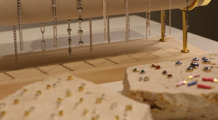 Elegant jewelry display at Solderella Studio, Melbourne, Victoria, AU showcasing intricate chains and stud earrings.
