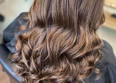 Glossy wavy hairstyle at SC Hair Design, Thirsk, England, GB. Perfect salon finish with rich brown tones.