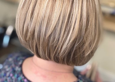 Blonde bob haircut crafted at SC Hair Design, Thirsk, England, GB. Showcases sleek styling and vibrant color.