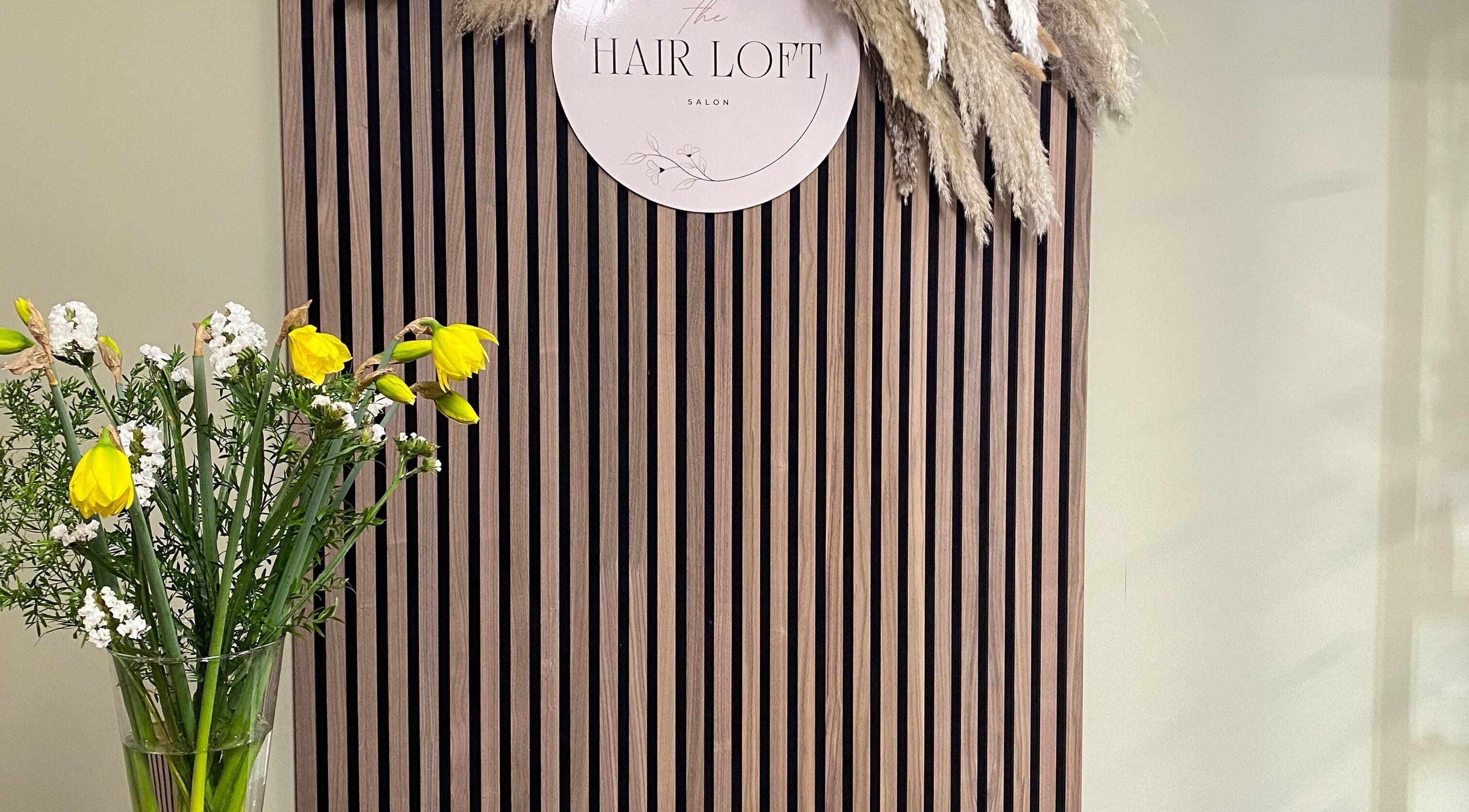 Stylish decor at SC Hair Design in Thirsk, England, featuring flowers on a striped wooden panel.