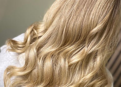 Blonde hair styled in soft waves at SC Hair Design, Thirsk, England, GB.