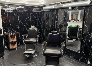 Modern barber chairs in B the barber, Tórshavn, Streymoyar, FO with sleek black marble decor.