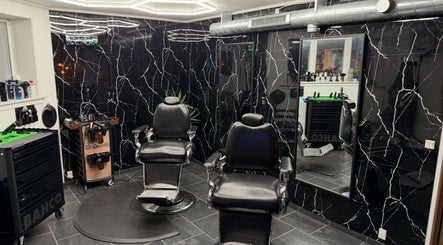 Modern barber chairs in B the barber, Tórshavn, Streymoyar, FO with sleek black marble decor.