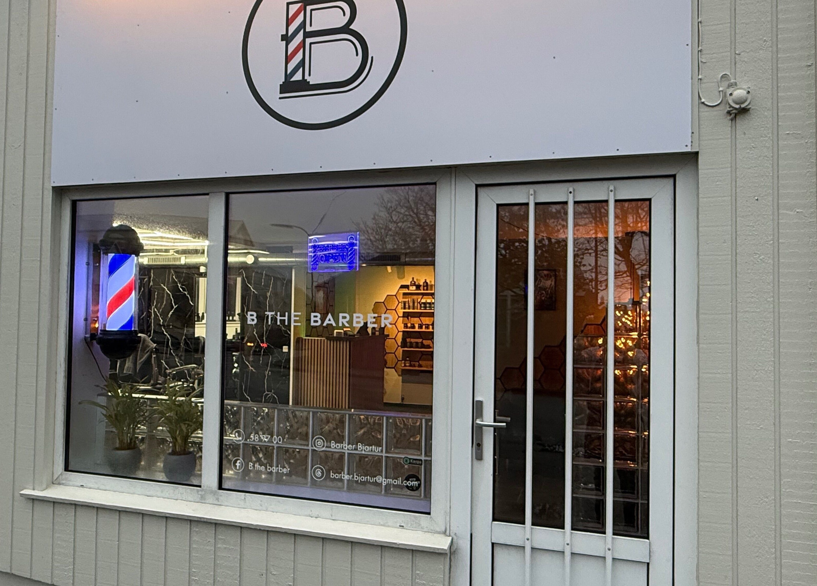 Front view of B the barber in Tórshavn, Streymoyar, FO with classic barber pole.