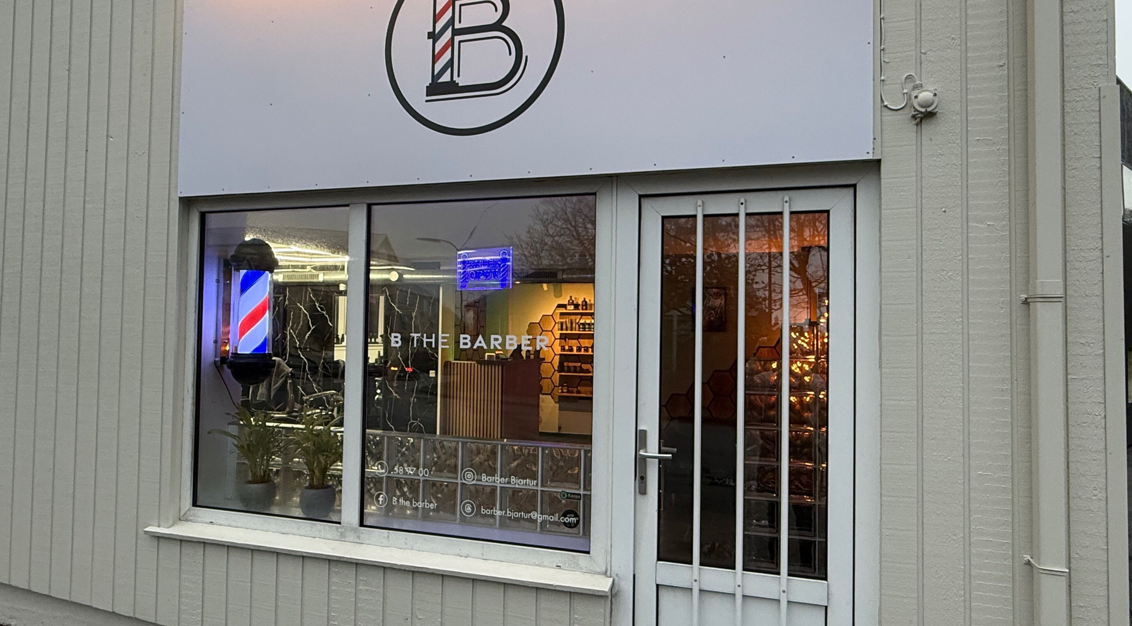 Front view of B the barber in Tórshavn, Streymoyar, FO with classic barber pole.