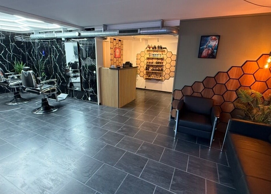 Sleek interior of B the barber in Tórshavn, Streymoyar, FO, showcasing stylish chairs and hexagon decor.