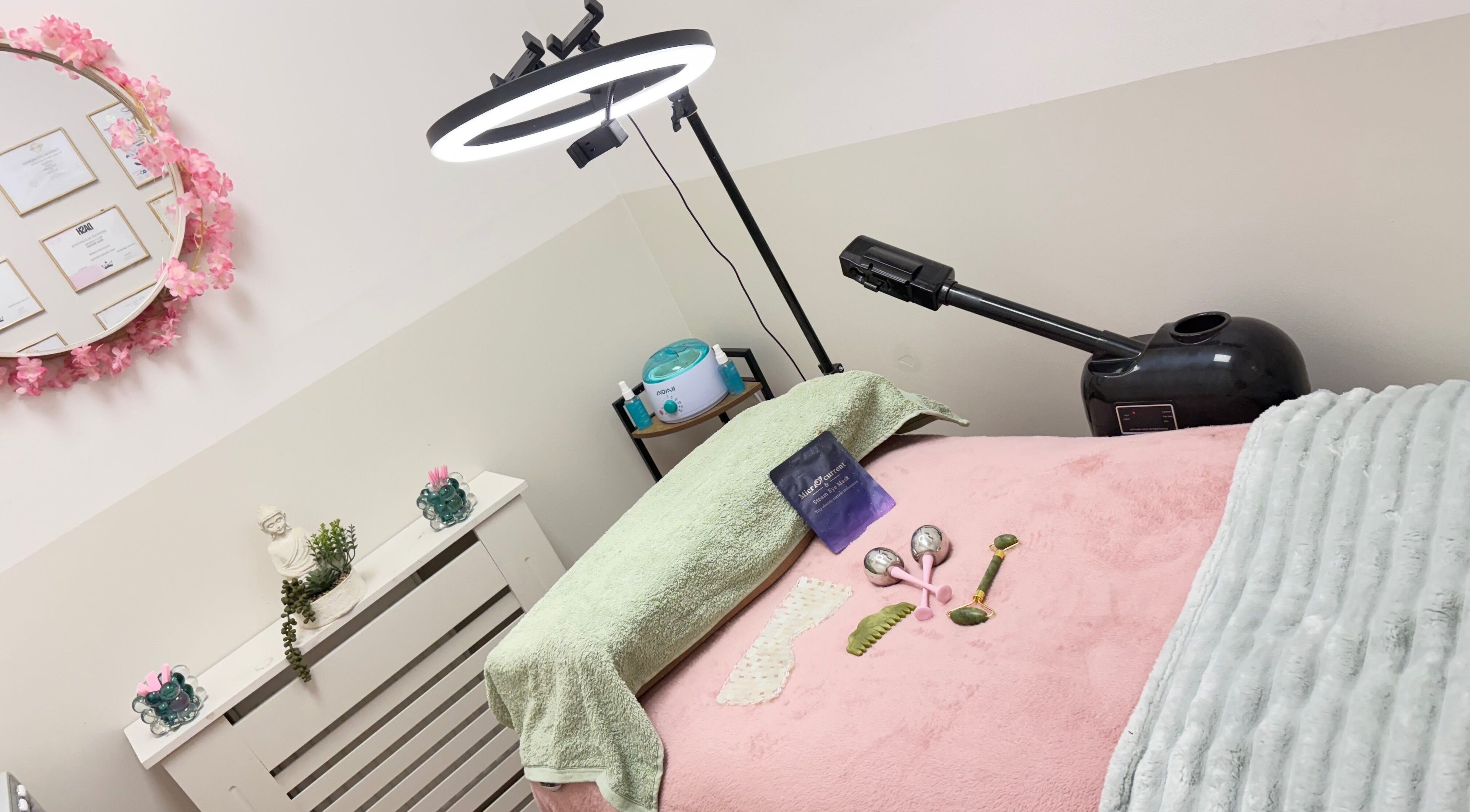 Cozy treatment room at Lotus Skin, Mansfield, England, GB, showcasing therapeutic tools and calming decor.
