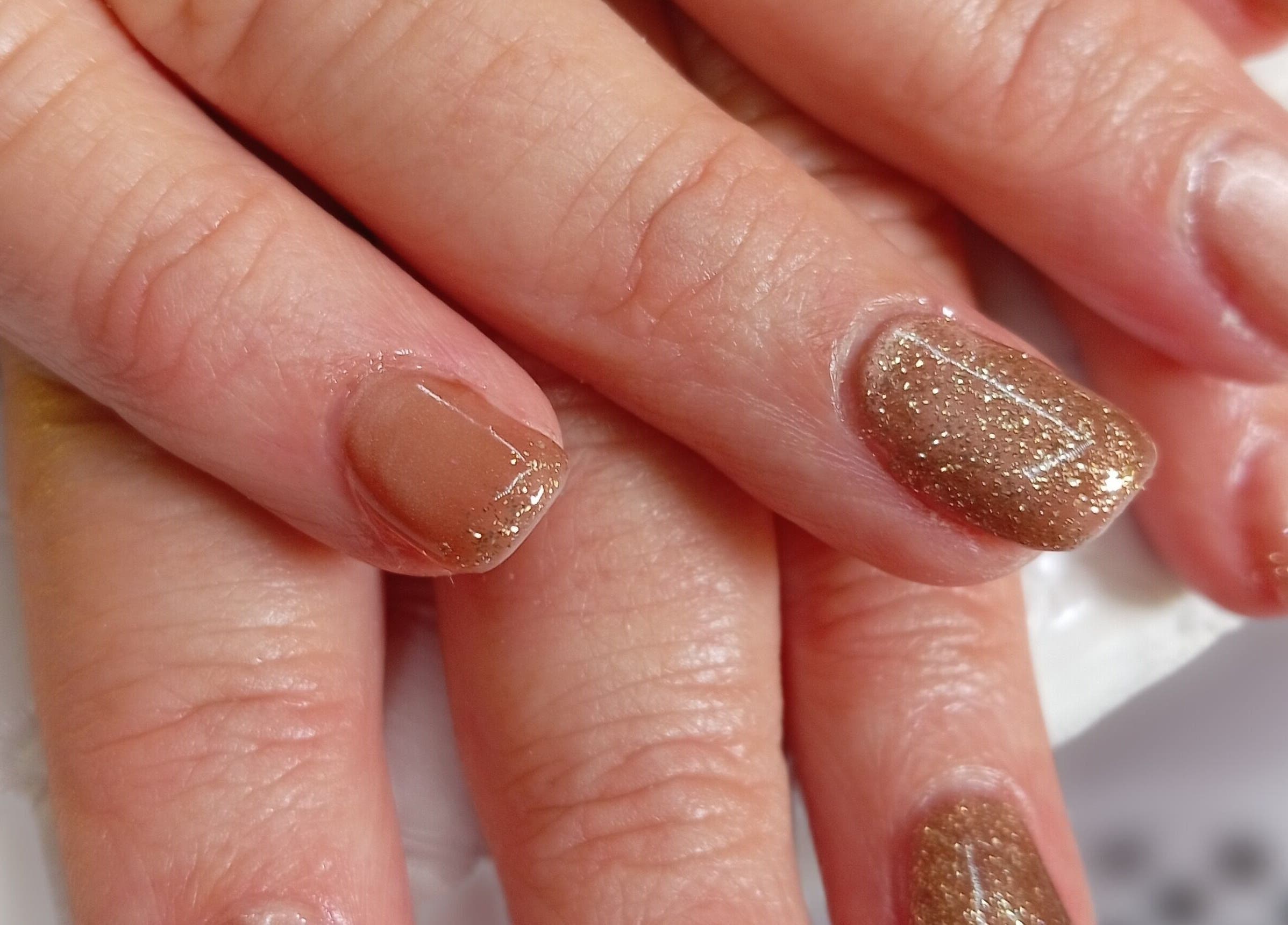 Gold glitter nails at Mari's Nail & Beauty Studio, Deneysville, Freestate, ZA showcase expert styling.