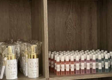 Lash care products at SK Beauty studio, Abu Dhabi, AE. Organized bottles on wooden shelves.
