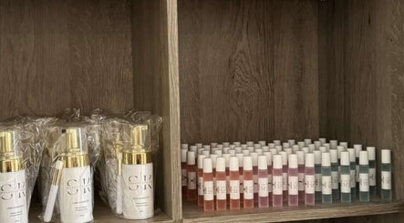Lash care products at SK Beauty studio, Abu Dhabi, AE. Organized bottles on wooden shelves.