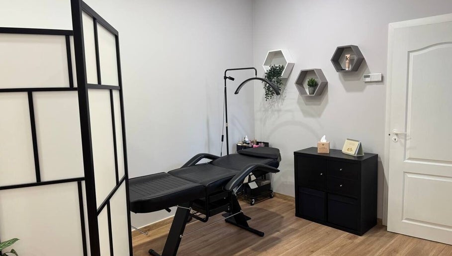 Modern treatment room at MSBeauty, Rīga, LV with massage table and stylish decor.
