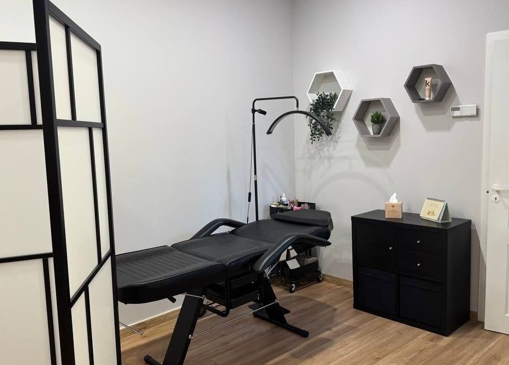 Modern treatment room at MSBeauty, Rīga, LV with massage table and stylish decor.