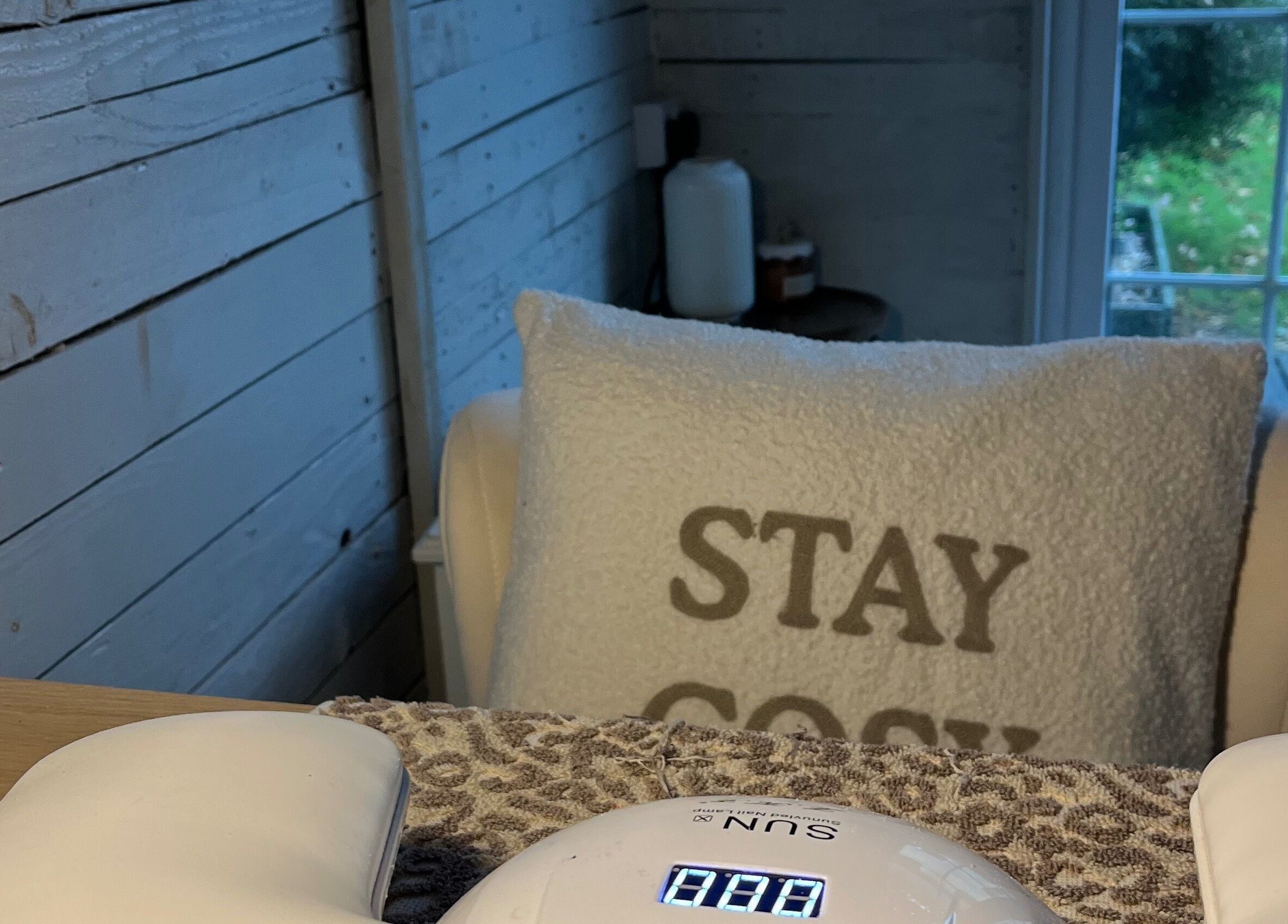 Cozy nail care setup at Glow Nails, Bournemouth, England, GB. Plush chair with 'Stay Cozy' pillow.