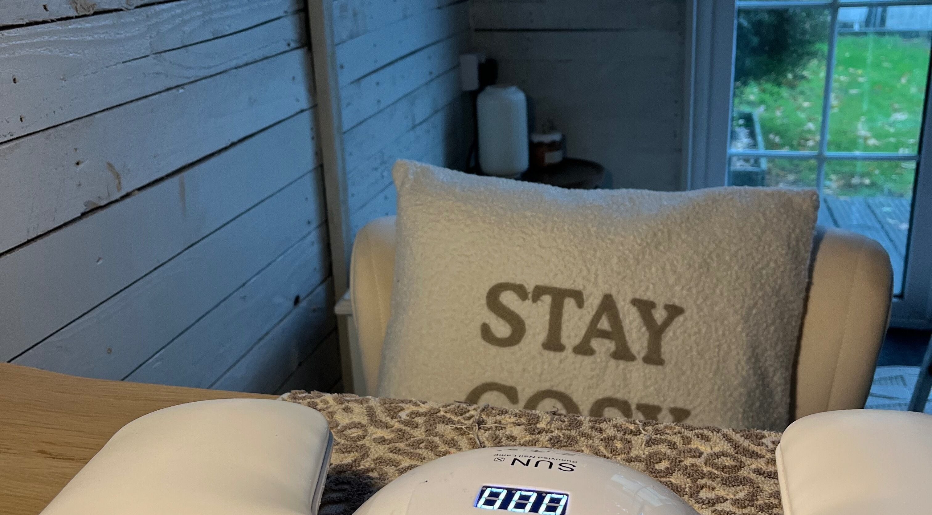 Cozy nail care setup at Glow Nails, Bournemouth, England, GB. Plush chair with 'Stay Cozy' pillow.